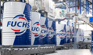 Fuchs logo on barrels which are blue and white in a warehouse